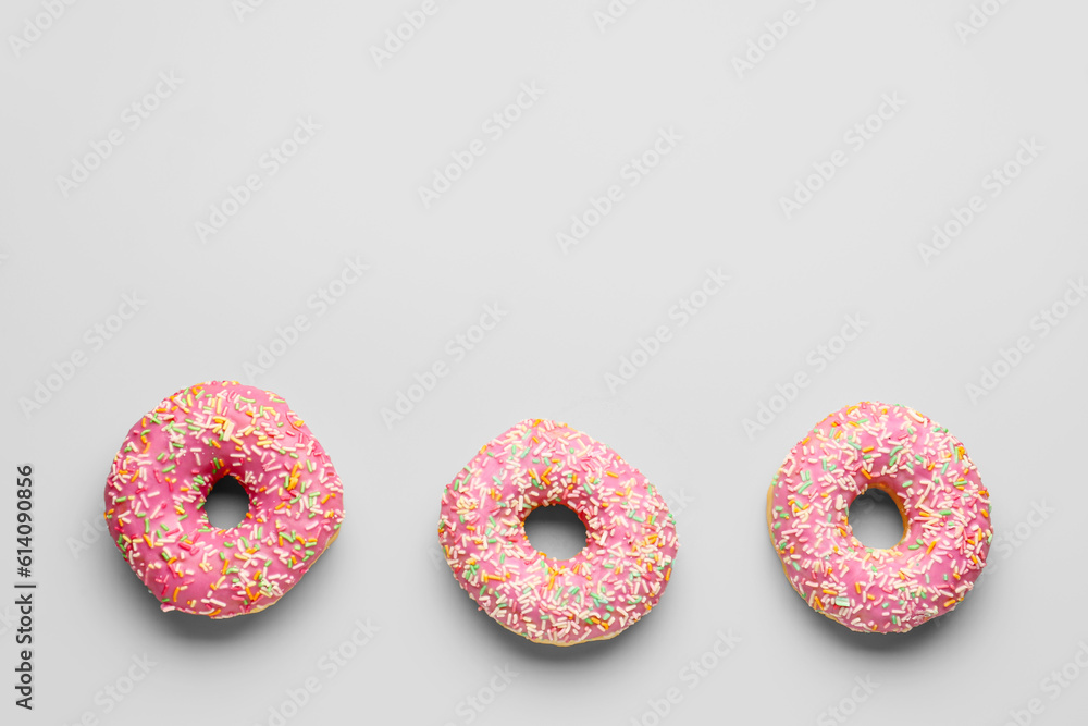 Sweet donuts on grey background