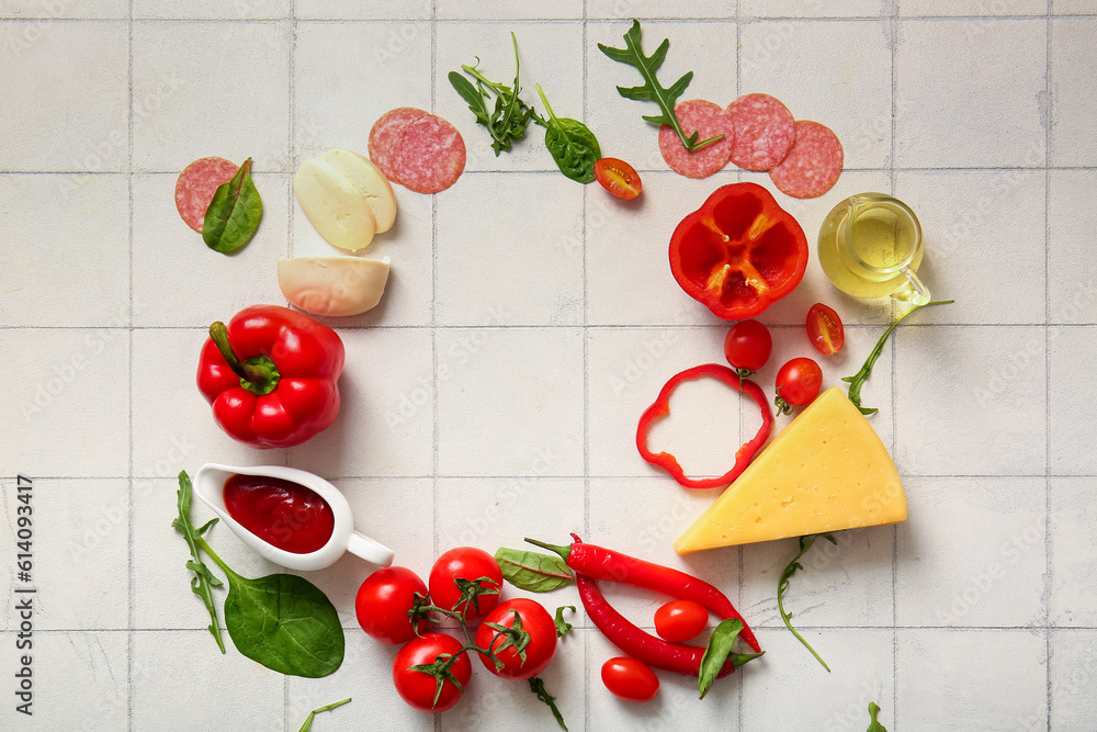 Frame made of ingredients for preparing pizza on white tile background