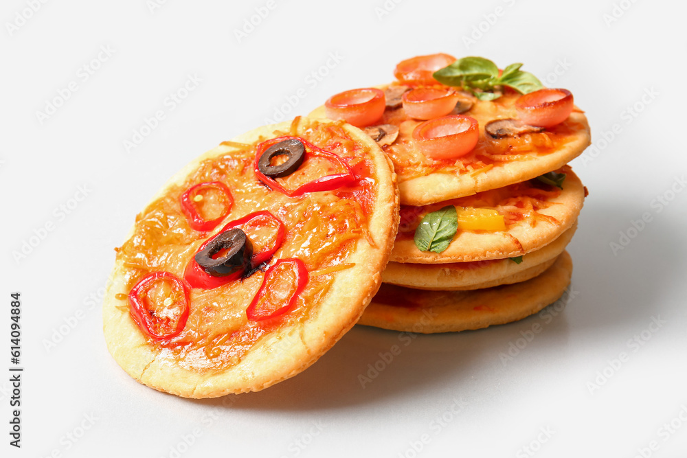 Different tasty mini pizzas on grey background