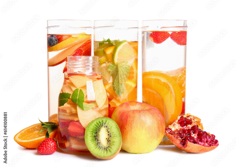 Bottles of infused water with different sliced fruits on white background