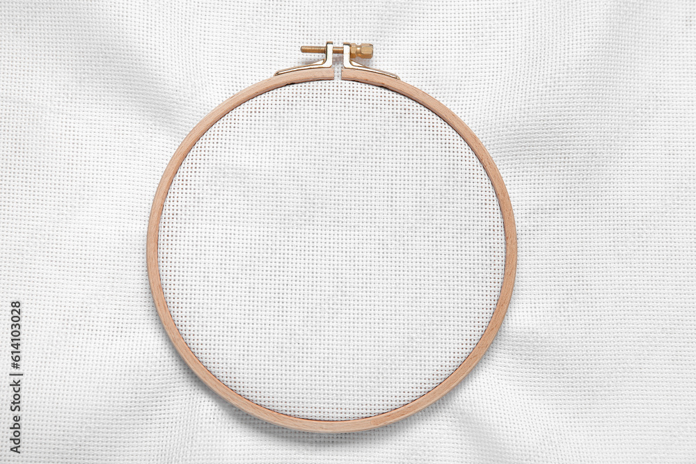 Wooden embroidery hoop with canvas as background