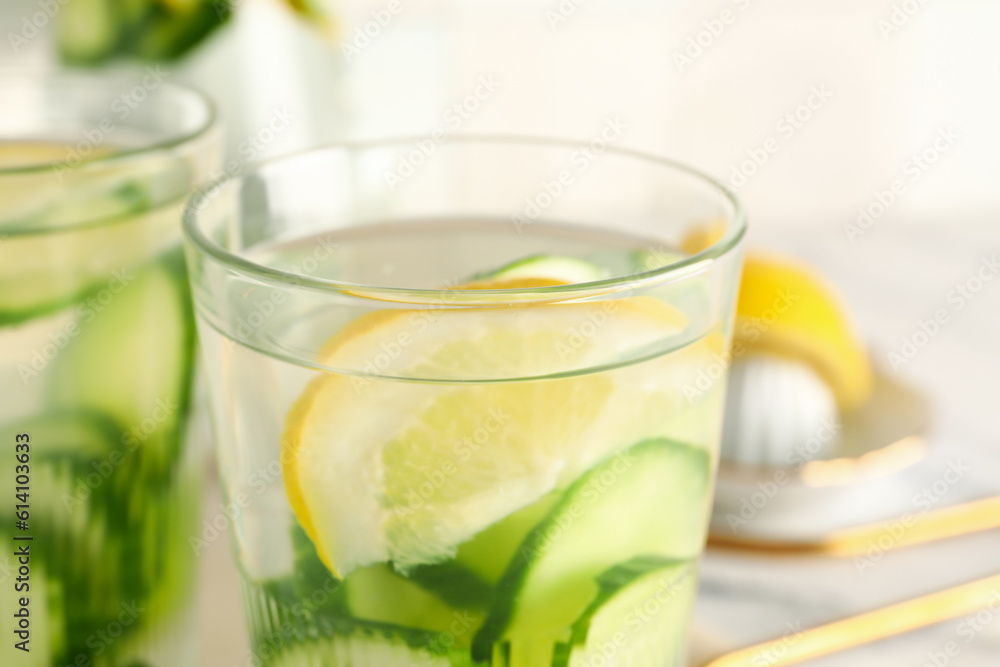 Glasses of infused water with cucumber slices, closeup