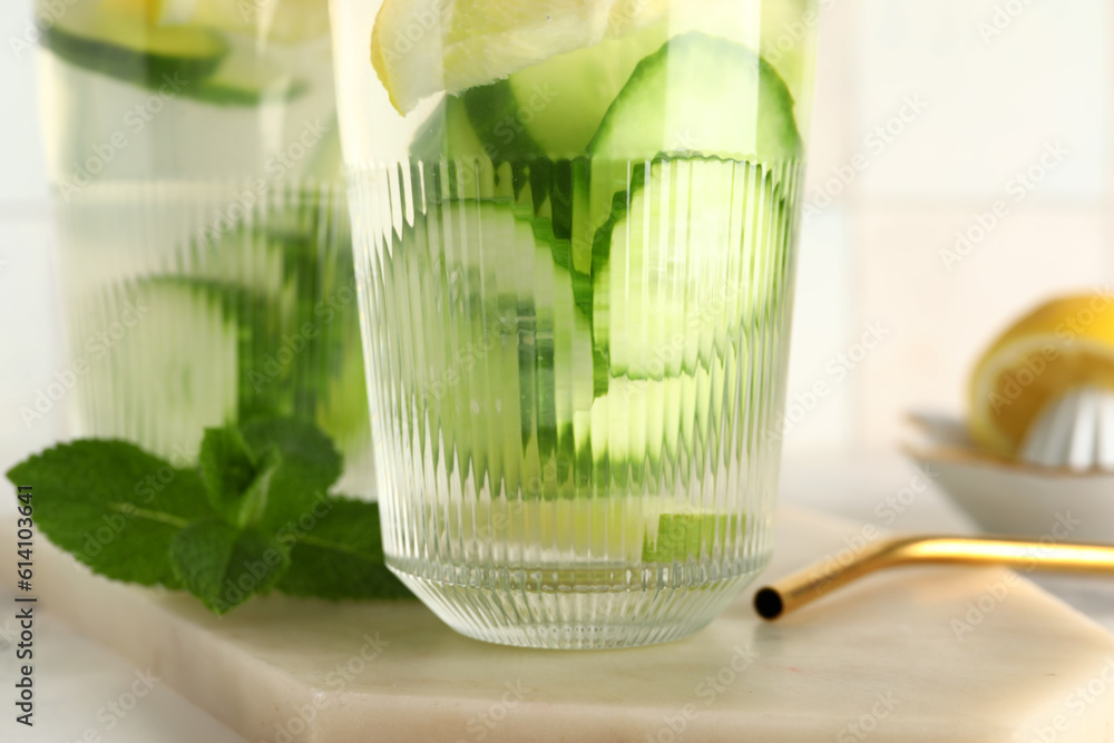 Glasses of infused water with cucumber slices, closeup