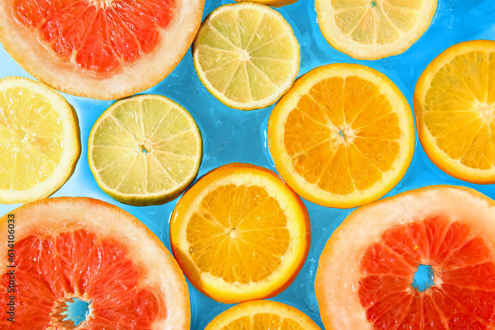 Different citrus fruit slices in water, closeup