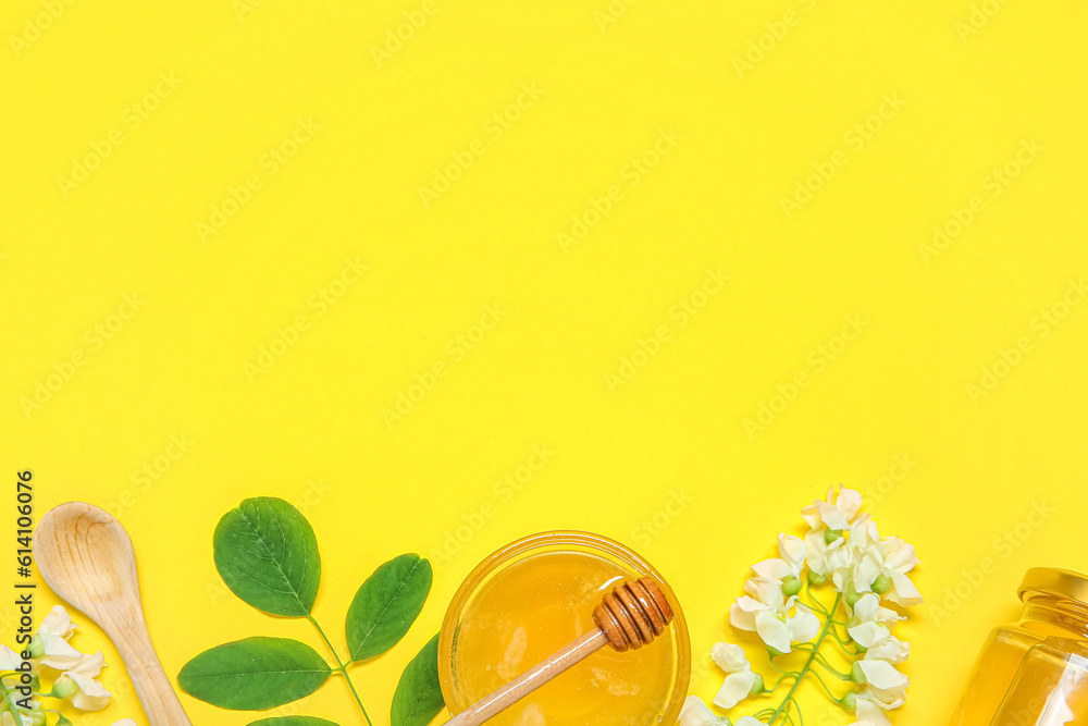 Composition with sweet honey and acacia flowers on yellow background