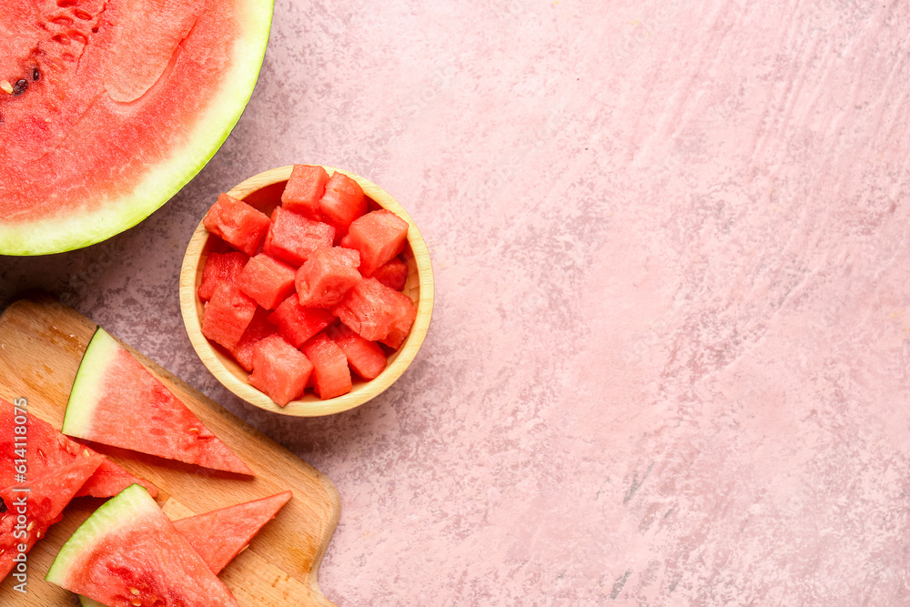 Board and bowl with pieces of fresh watermelon on pink background