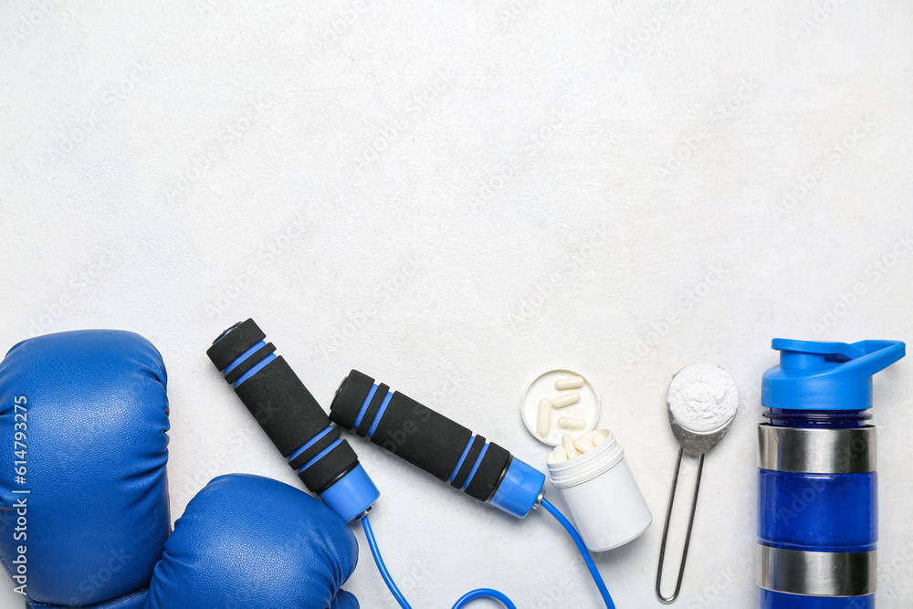 Sports equipment, bottle of water, amino acid pills and powder on light background