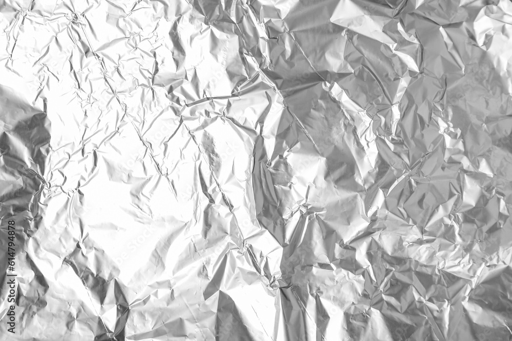 Texture of crumpled aluminium foil as background, closeup