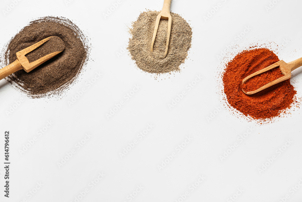 Wooden scoops of fresh spices on light background