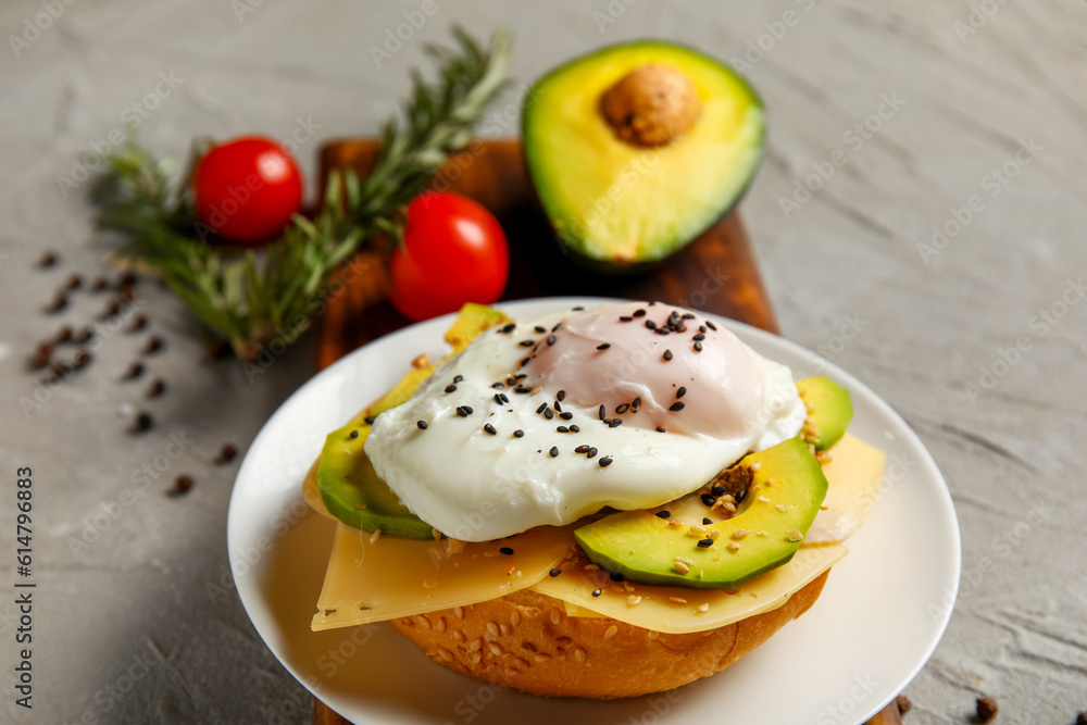 Plate with tasty egg Benedict on grey background, closeup