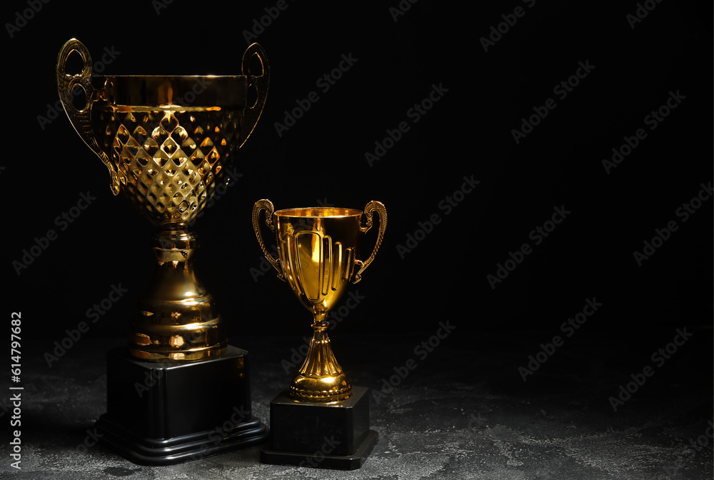 Gold cups on dark background