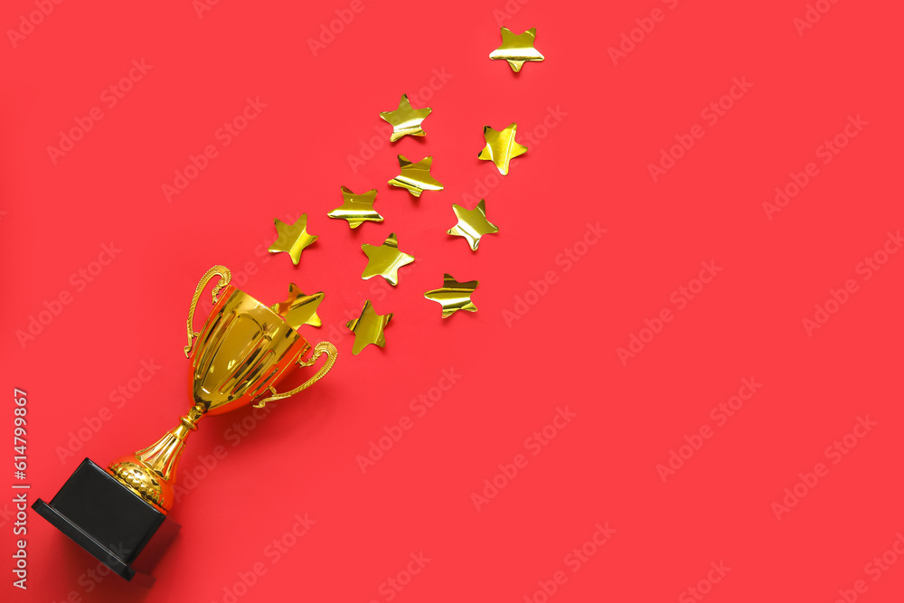 Gold cup with stars on red background