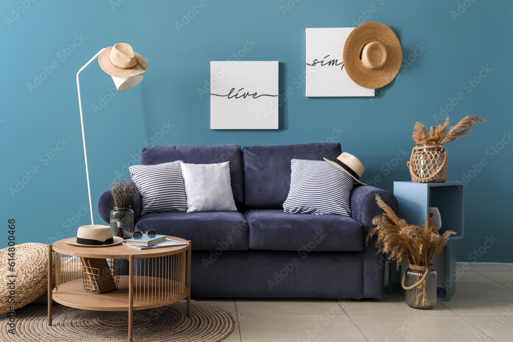 Interior of cozy living room with blue sofa and coffee table