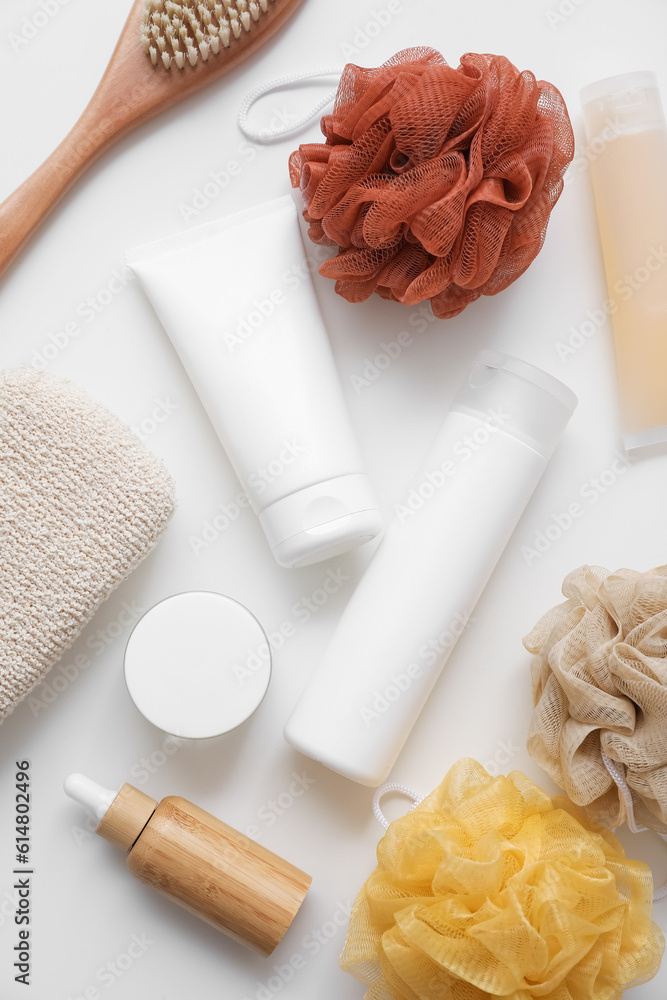 Bath accessories with loofahs on white table, top view