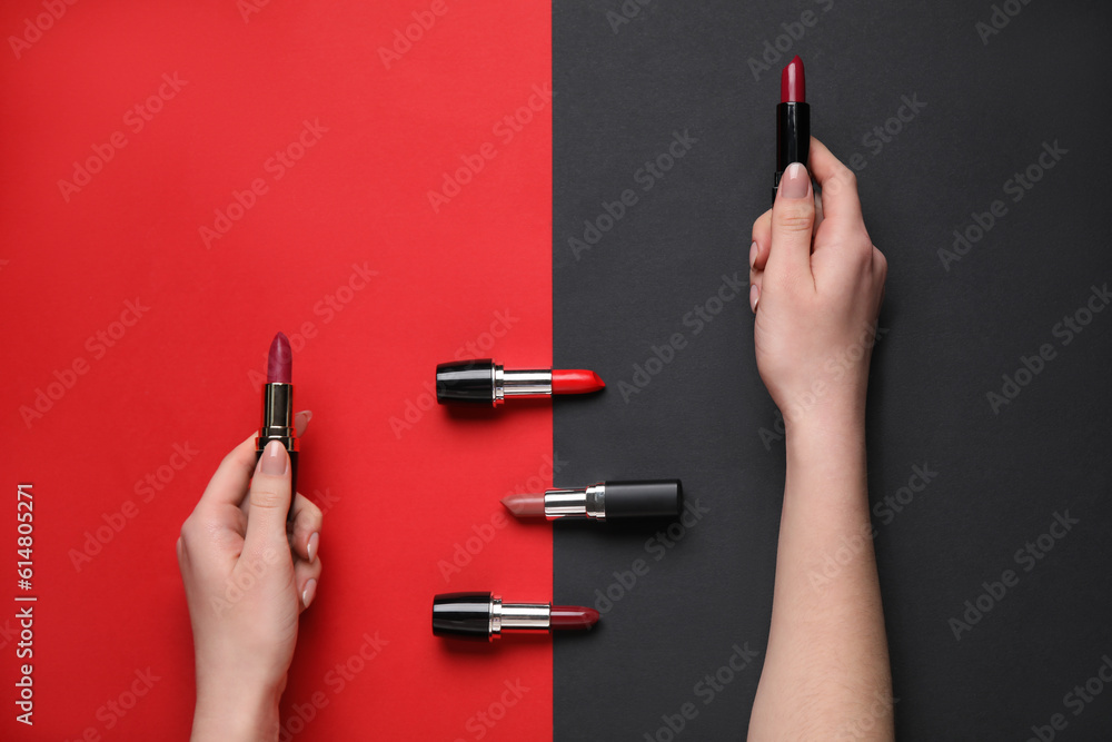 Woman with lipsticks on color background