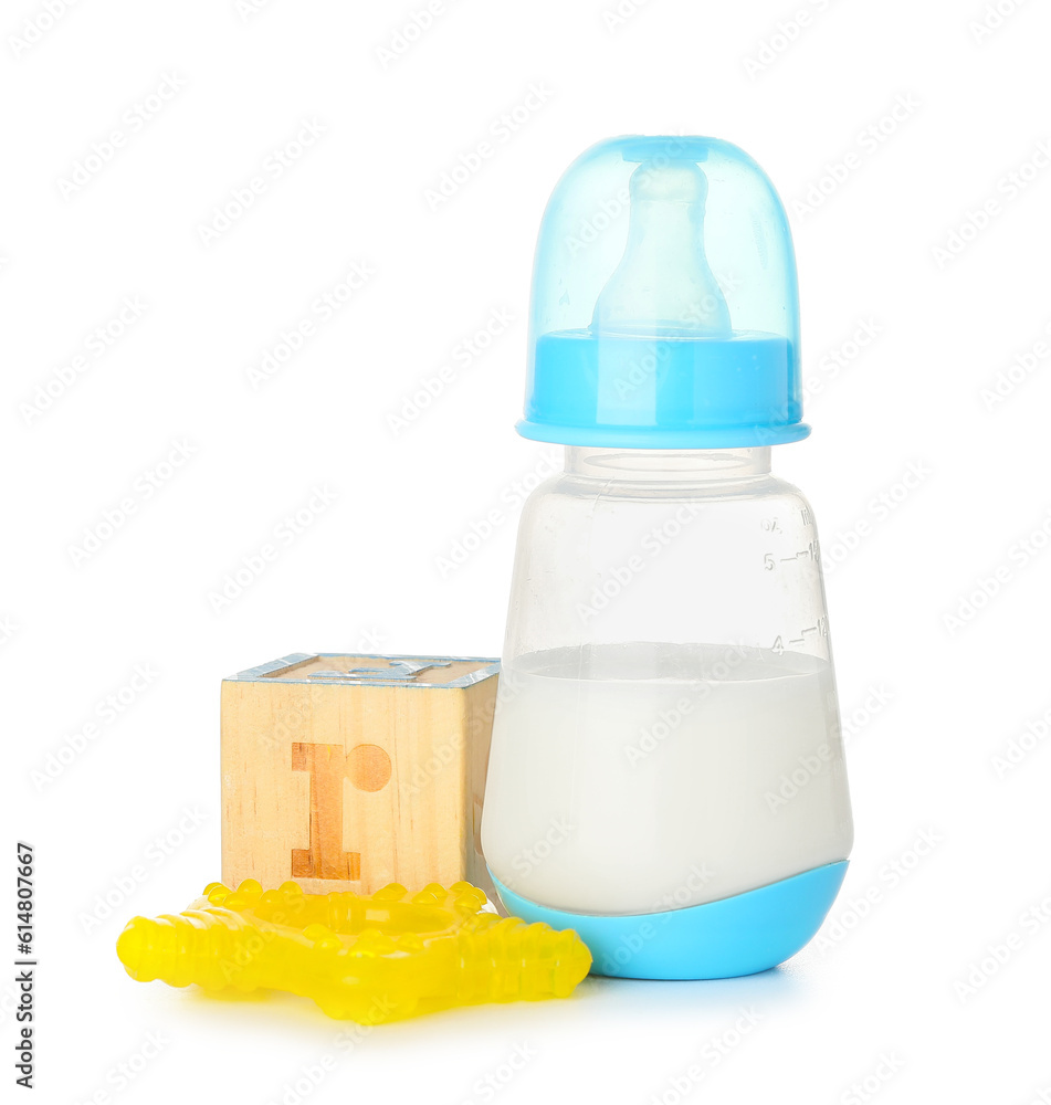 Bottle of milk for baby with toys isolated on white background