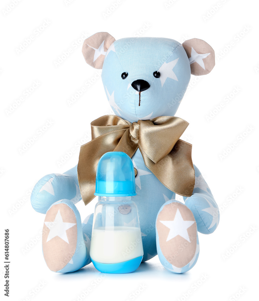 Teddy bear with bottle of milk for baby isolated on white background