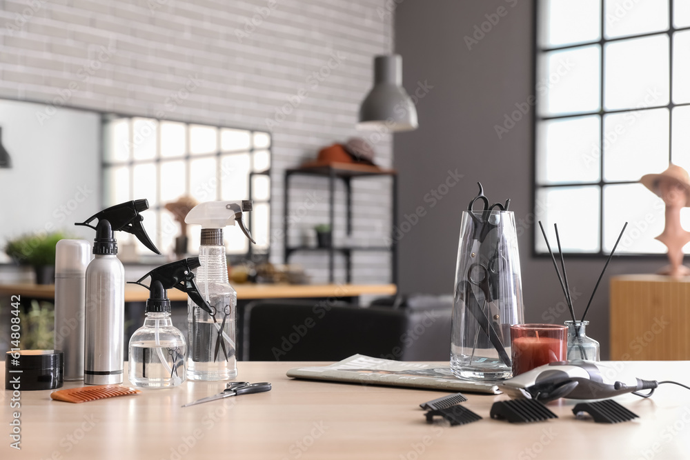 Different hairdressing tools on table in beauty salon