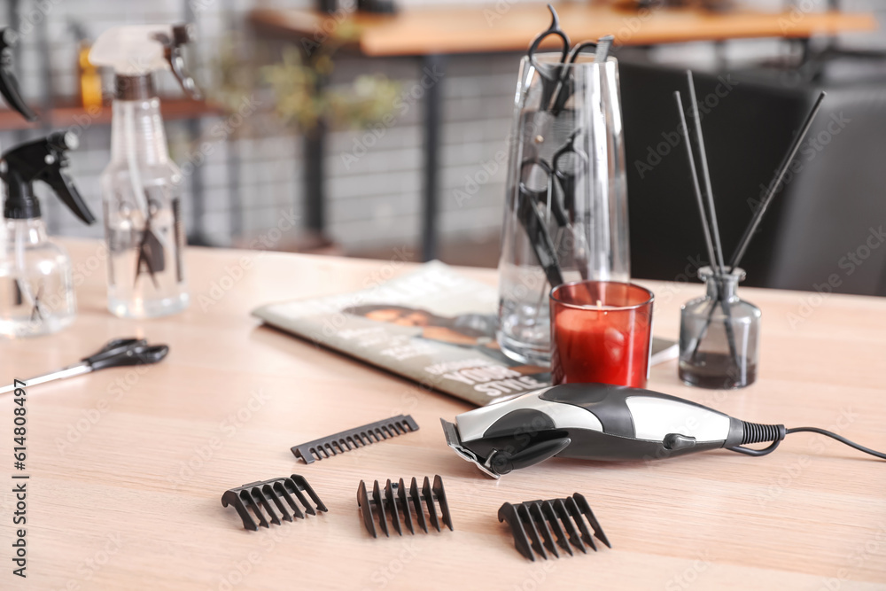 Trimmer with attachments on table in beauty salon