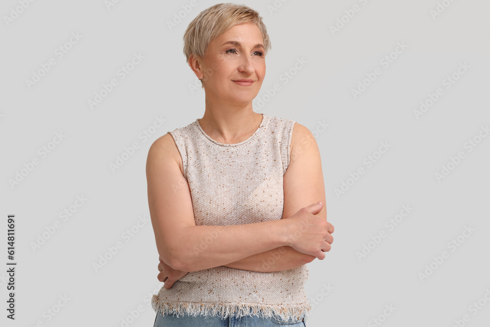 Mature blonde woman on light background