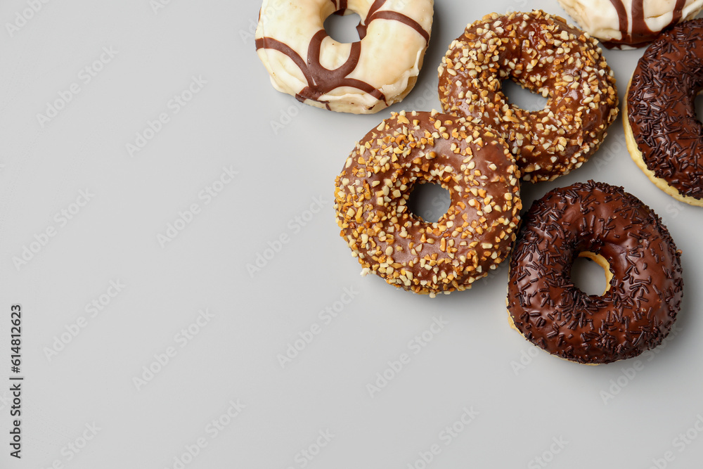 Sweet chocolate donuts on grey background