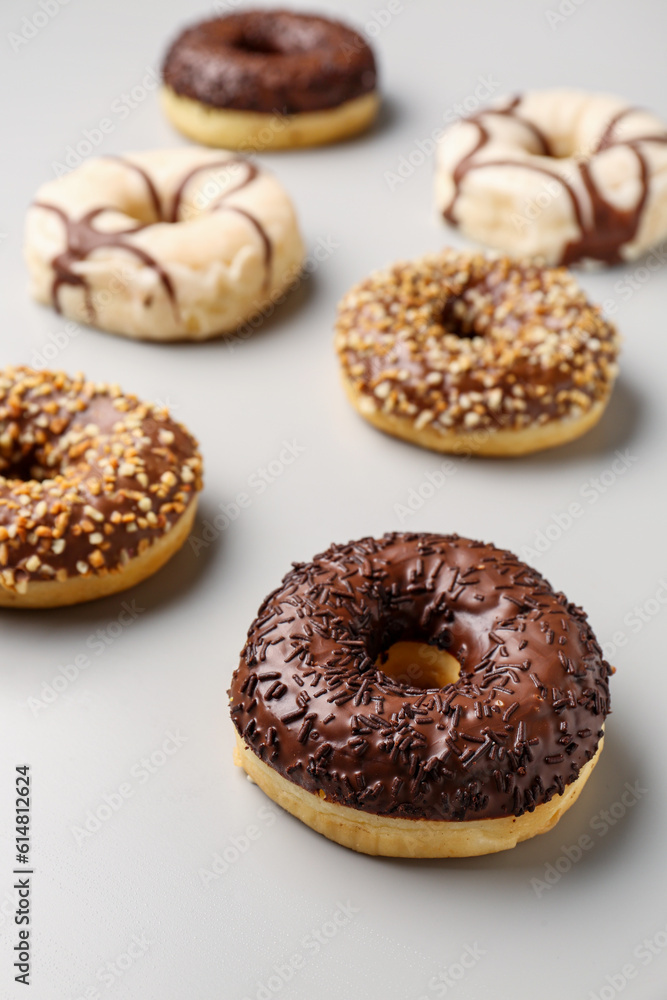 Sweet chocolate donuts on grey background