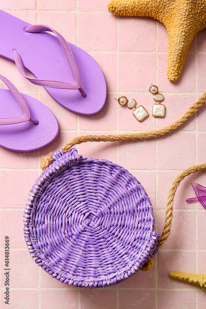 Stylish bag and different accessories on pink tile background