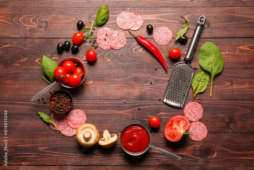 Frame made of fresh ingredients for preparing pizza on wooden background