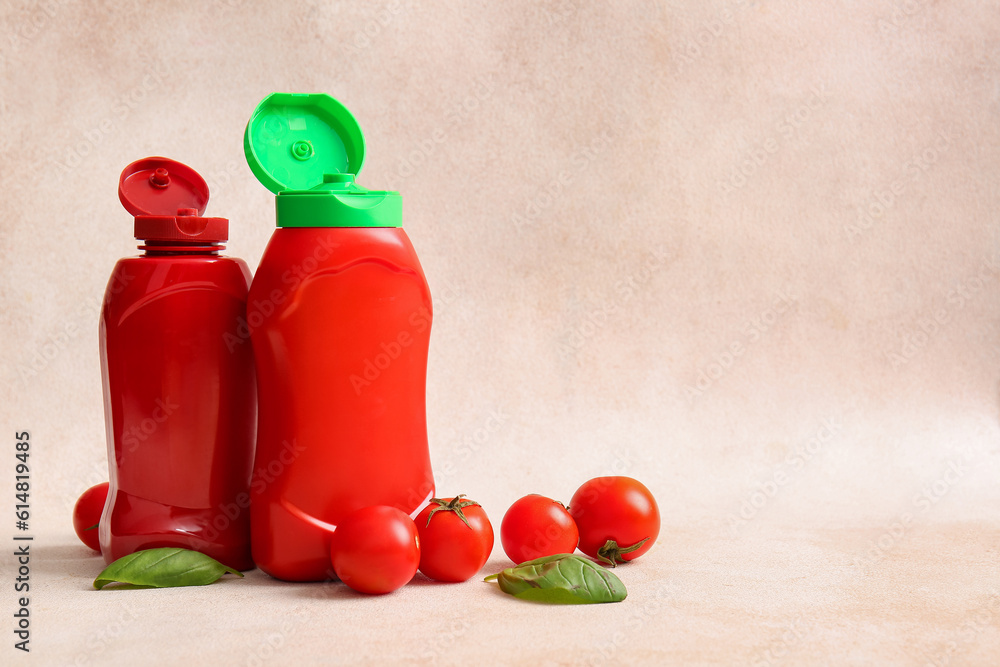 Bottles of ketchup and tomatoes on white background