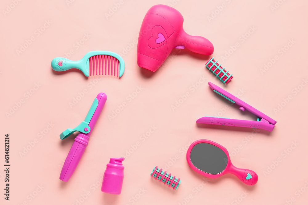 Frame made of different hairdressing accessories on pink background. Childrens Day celebration