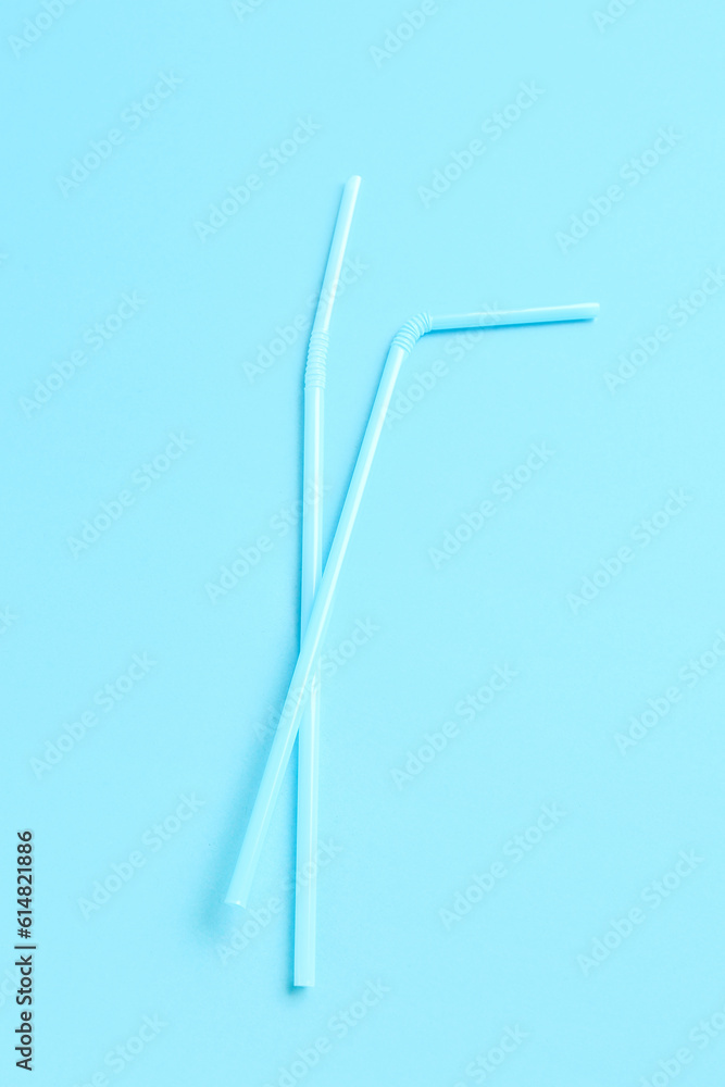 Plastic straws on blue background