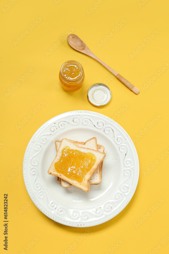 Plate of tasty toasts and jam on color background