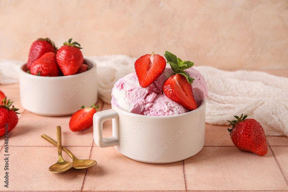 Cup with delicious ice cream, fresh strawberries and mint on pink table