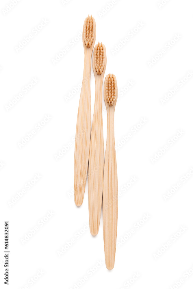 Bamboo toothbrushes on white background