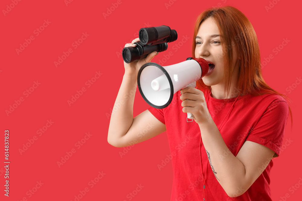 Female lifeguard with binoculars shouting into megaphone on red background