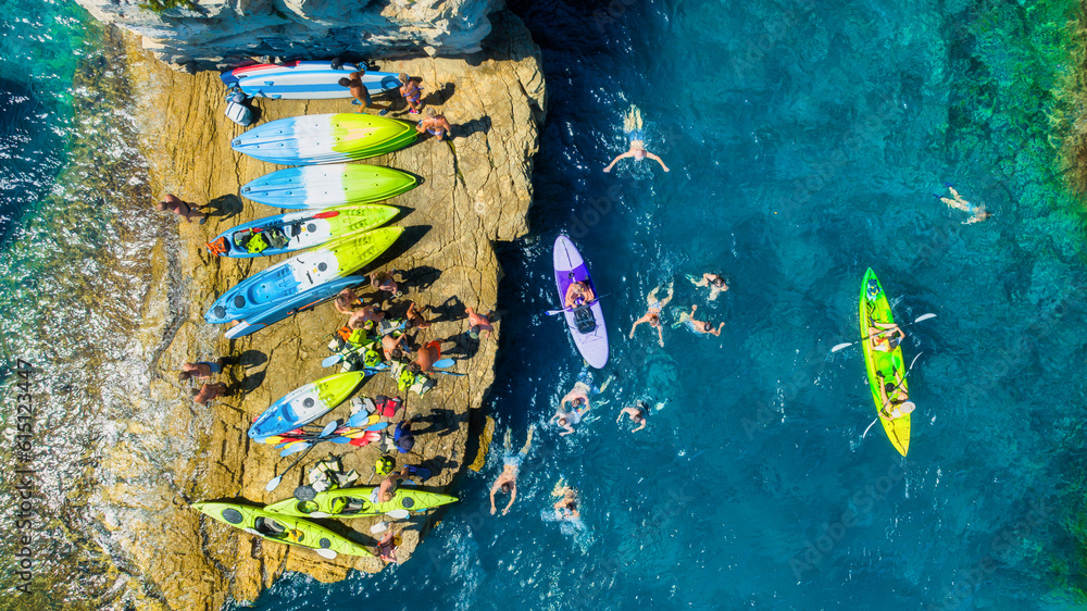 Kayaking. Sup. Aerial view of floating board and people on blue sea at sunny day. Travel and active 