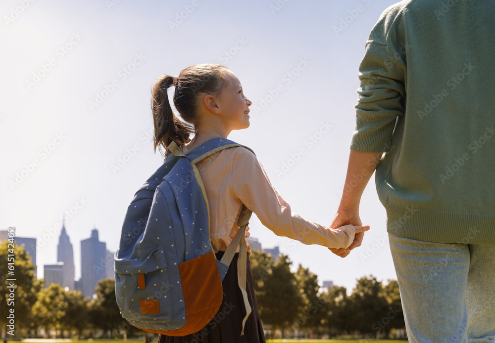 Parent and pupil going to school