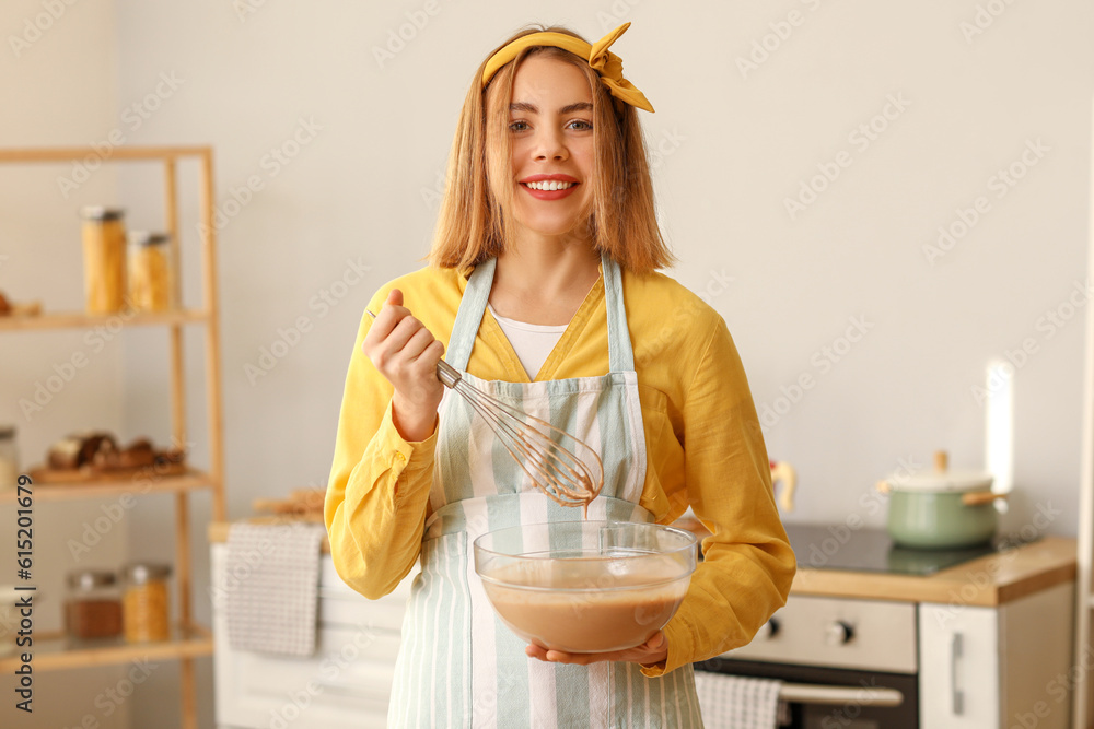 Female baker making dough in kitchen