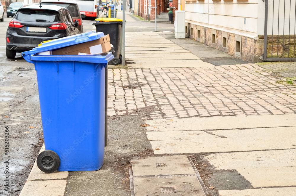 Garbage containers with trash on city street