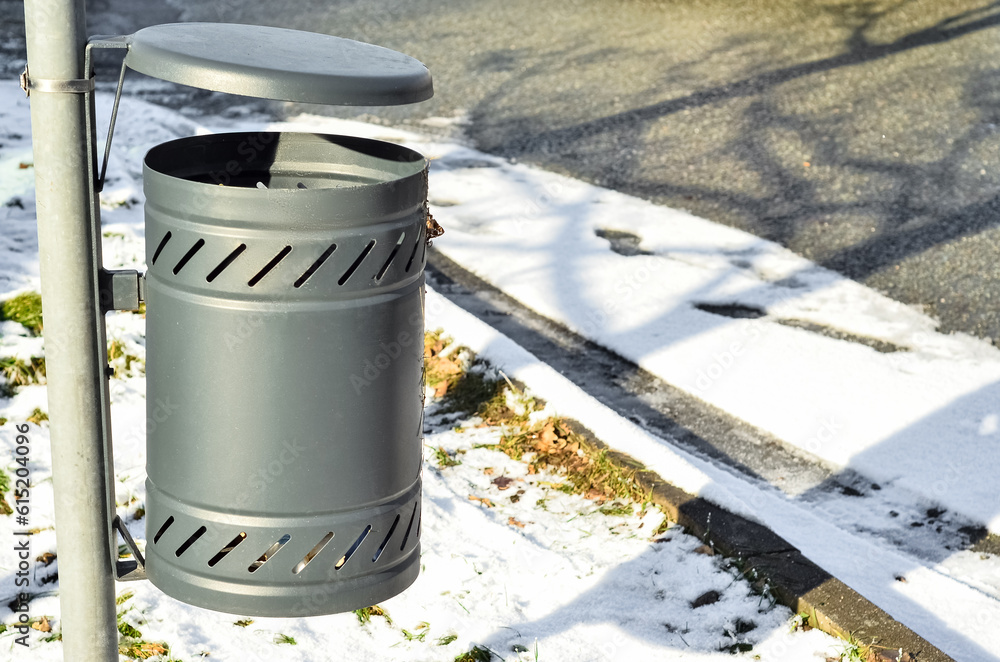 View of trash bin in city on winter day