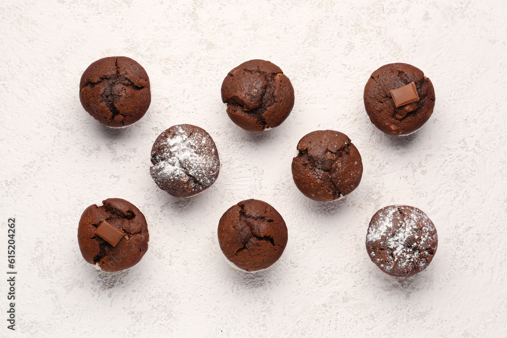 Tasty chocolate cupcakes on light background