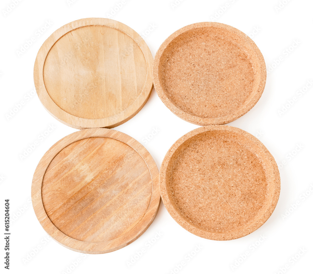 Wooden kitchen boards and cork plates on white background