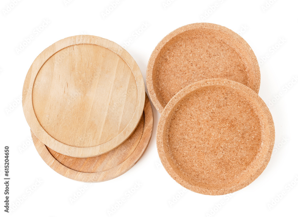 Wooden kitchen boards and cork plates on white background