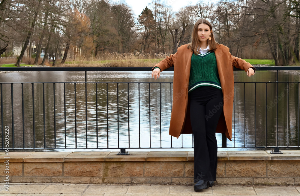 Stylish young woman on embankment