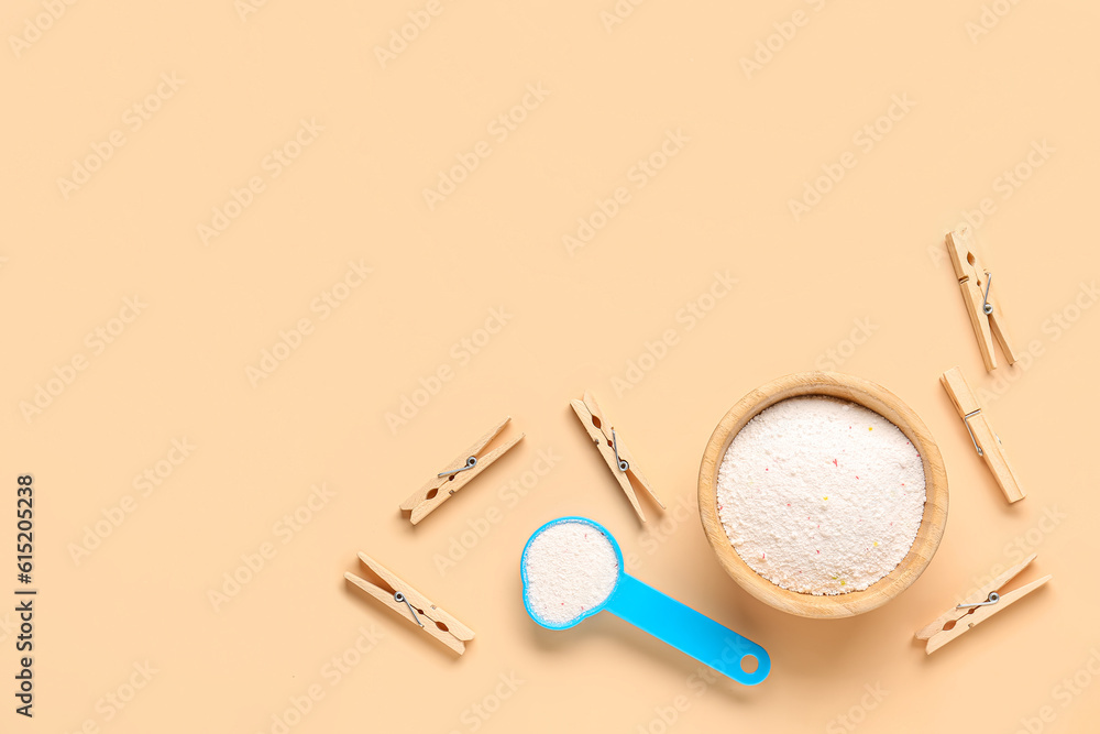 Laundry detergents and clothespins on beige background