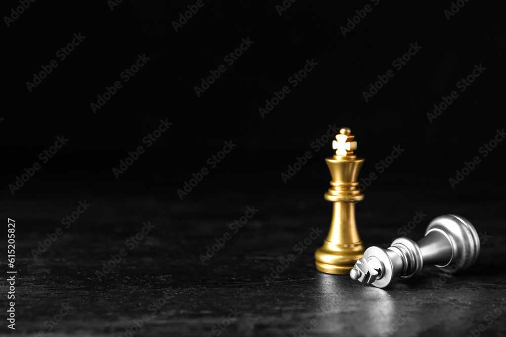 Chess pieces on dark background. Loser concept