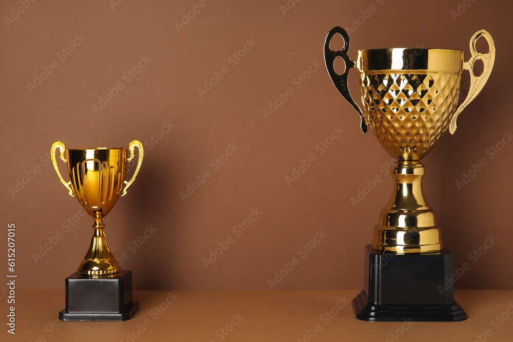 Gold cups on brown background