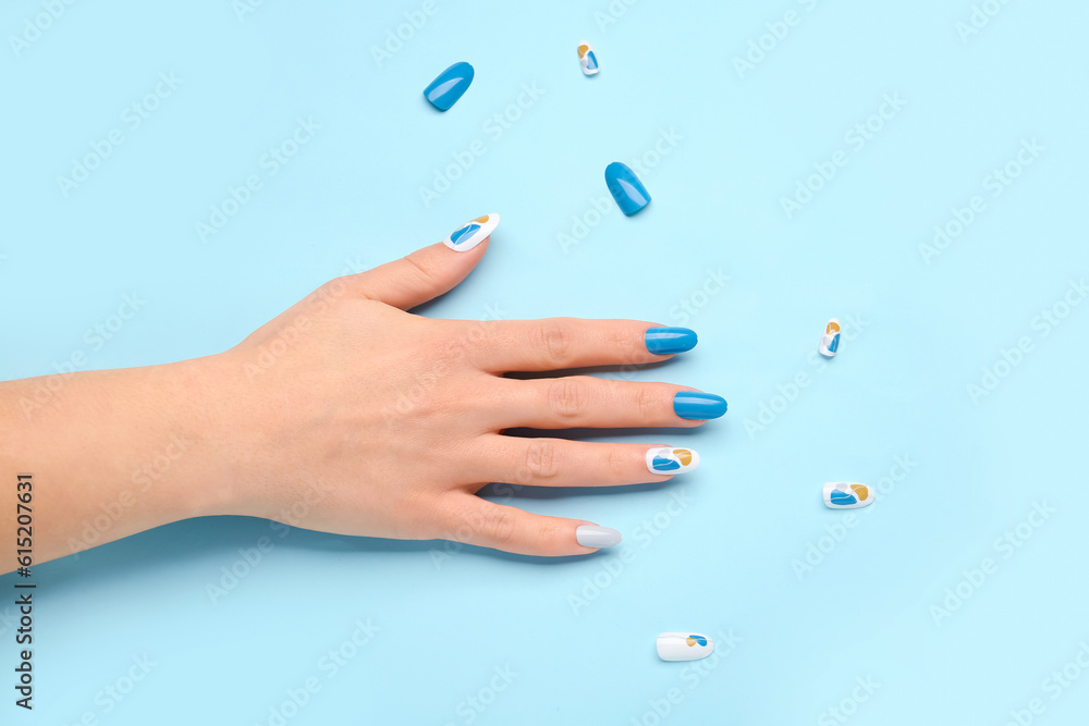 Woman with press-on nails on blue background