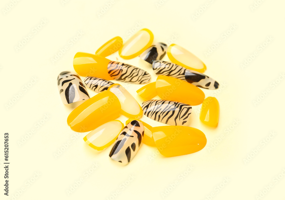 Press-on nails on yellow background