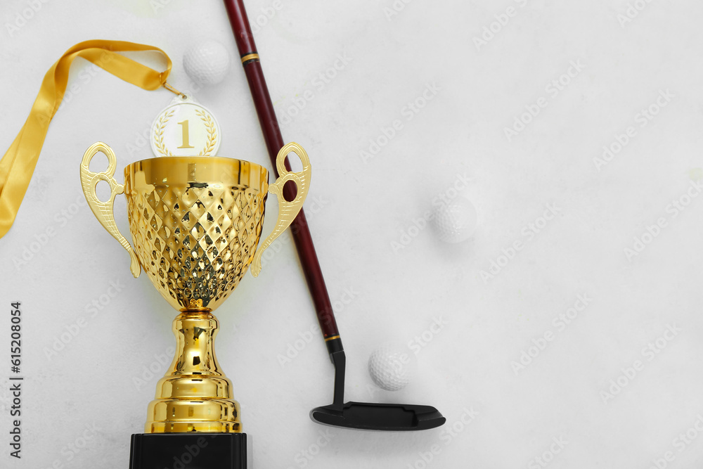 Gold cup with golf club and balls on white background